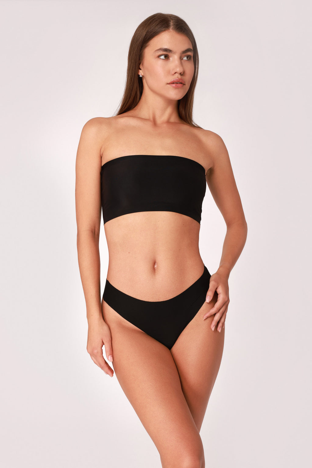 Model wearing a black JUA NUR lingerie set on a white background