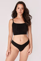 Model wearing a black JUA NUR lingerie set on a plain background