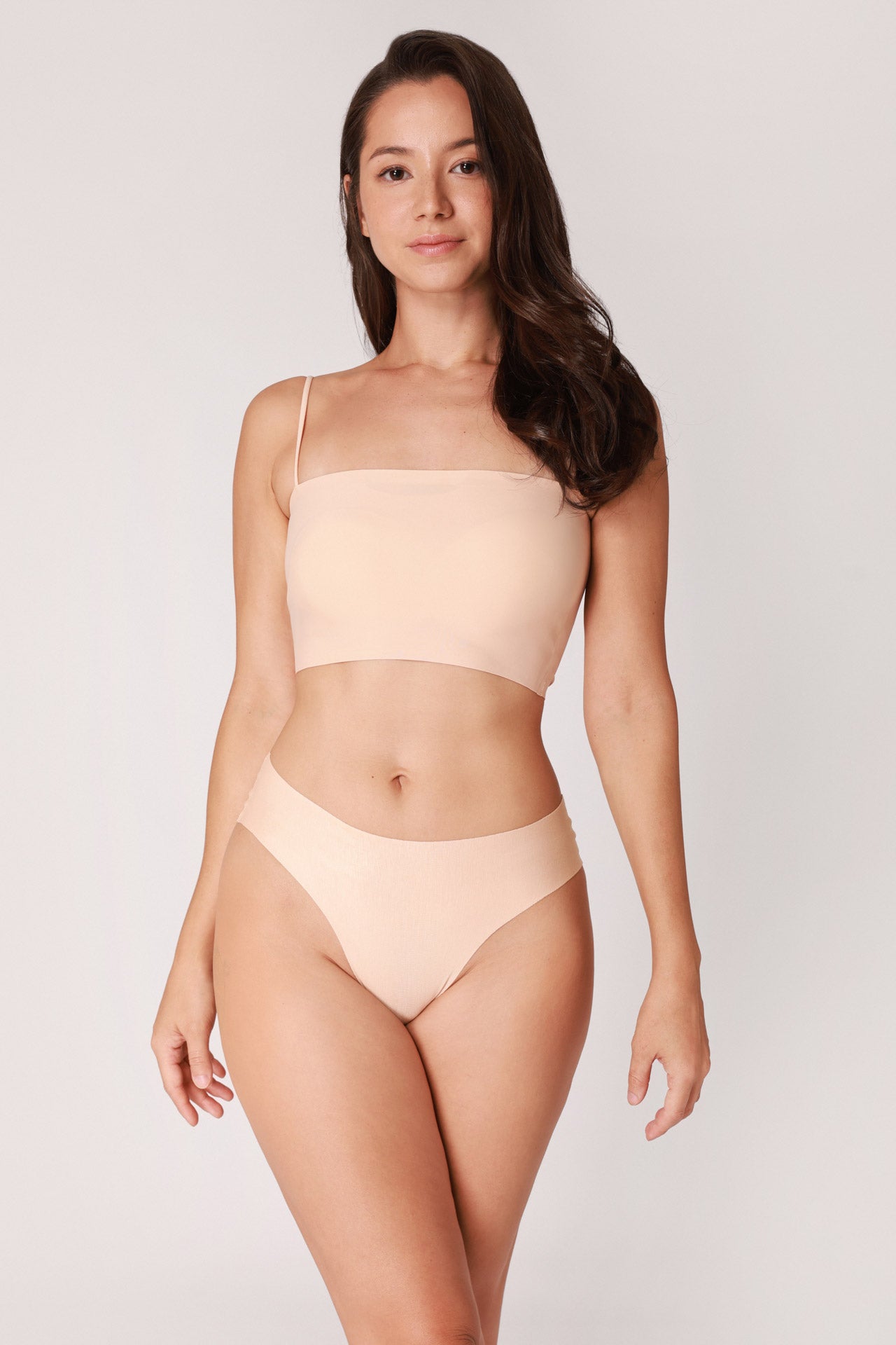 Model wearing a beige JUA NUR lingerie set on a plain background